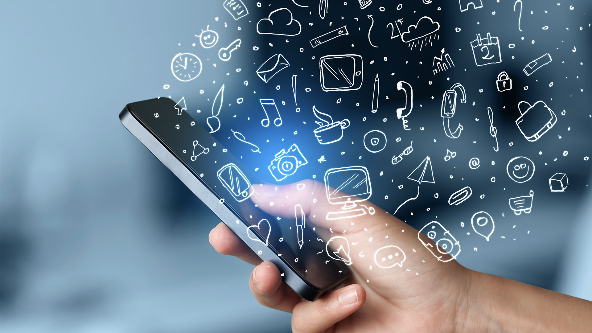app development company that's trying to demonstrate a hand holding a phone wit lots of symbols